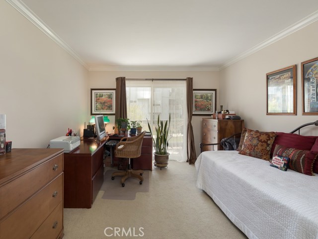 Second bedroom is also good sized and also has slider door leading to patio.  There is a large, mirrored wardrobe on wall not visible in the photo.