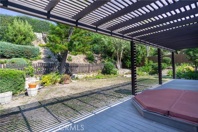 A view of the backyard looking up towards the hill in back with steps up to an observation deck.
