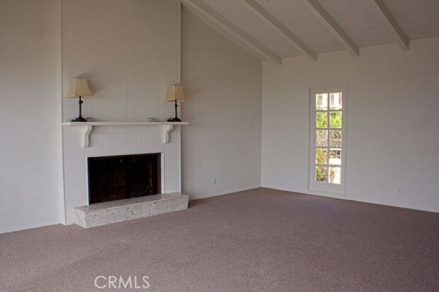 living room with vaulted ceiling overlooks view and courtyard