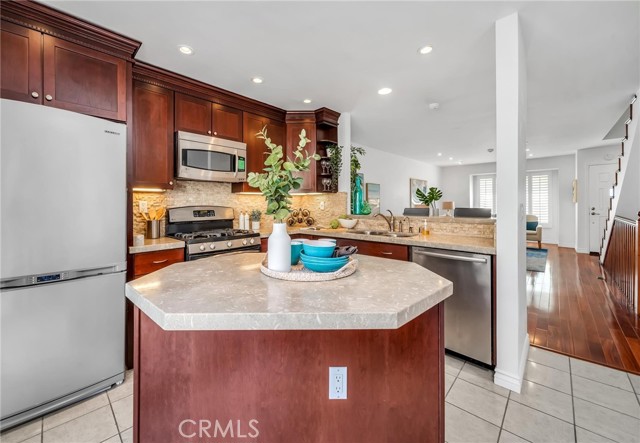 Stainless steel appliances with limestone countertops.