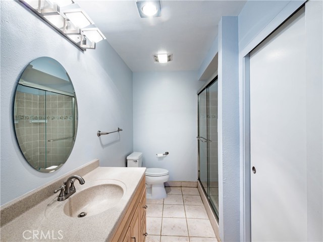Master bath has a newer vanity, tile floor, and huge tile shower with glass doors. Master suite includes a walk in closet and a wall closet as well as a slider to the balcony with pretty views.