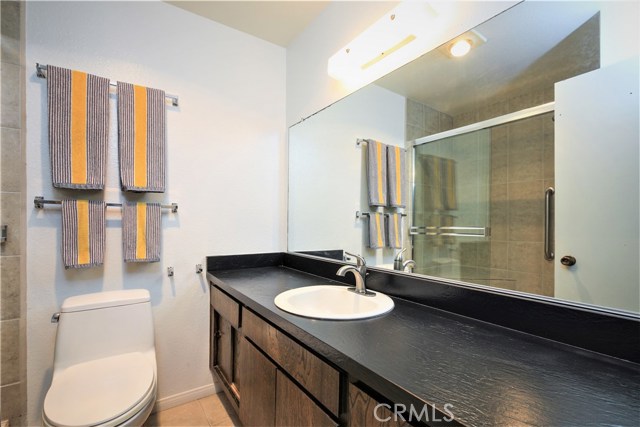 The Full Bath has a Large Vanity with Ample Storage and a Large Glass Enclosed Walk-in Shower.  The Bathroom can be Easily Remodeled and Modernized.