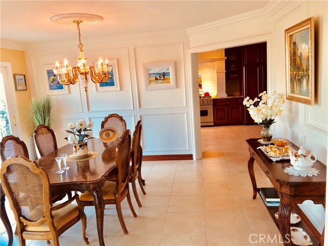 Photo of Formal Dining towards New Kitchen with Top-of-the Line Appliances Kitchen has both a Panoramic City View standing at the Kitchen sink and a View of the Private Garden in the family area with fireplace