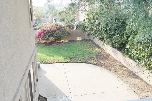 Large Backyard Features Lots of Grassy Area On The Side Along With A Large Concrete Patio.