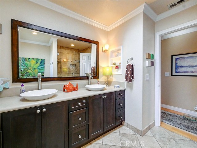 Large and lovely hall bathroom with double vessel sinks.