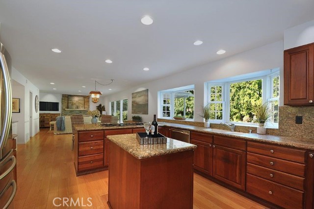 Updated kitchen with granite counters, 6 burner Jennair Cooktop and Cherry Cabinets.