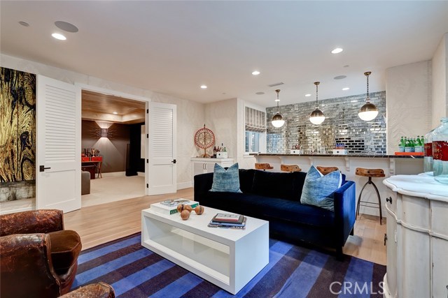 Downstairs family room adjacent to theater.  Mirrored brick wall adorns the wet bar backsplash