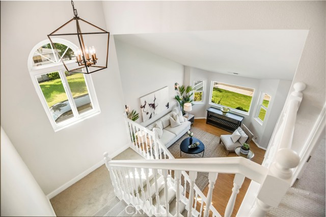  Bright, two-story stairwell with new contemporary hanging lantern.