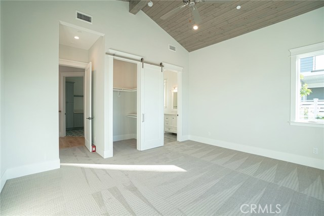 View of bedroom 1 walk-in closet, private bathroom from bay window area.