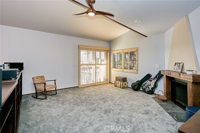 This spacious den makes a perfect music room, sports room, gym, library, children's playroom, or whatever you imagine it could be, with a nice little balcony outside the wooden shuttered patio door.