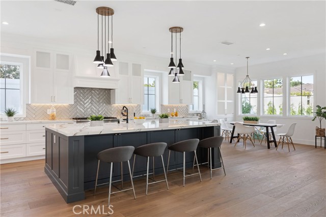 Tradionally dramatic with stylish backsplash and full height custom cabinetry