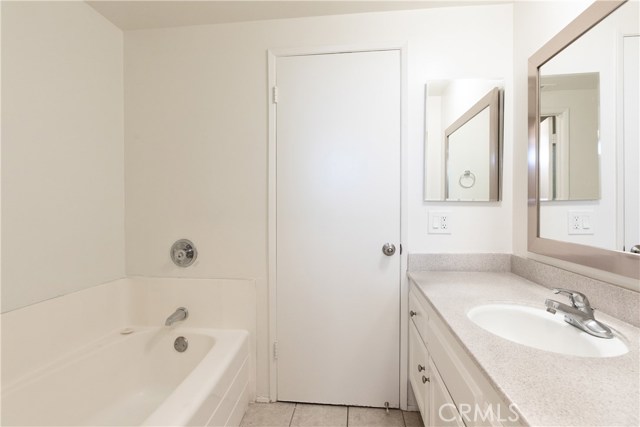 The bathroom on this floor offers access from the main hallway as well as private access from the master bedroom. This area with a vanity and bath tub, opens out to the main hallway.