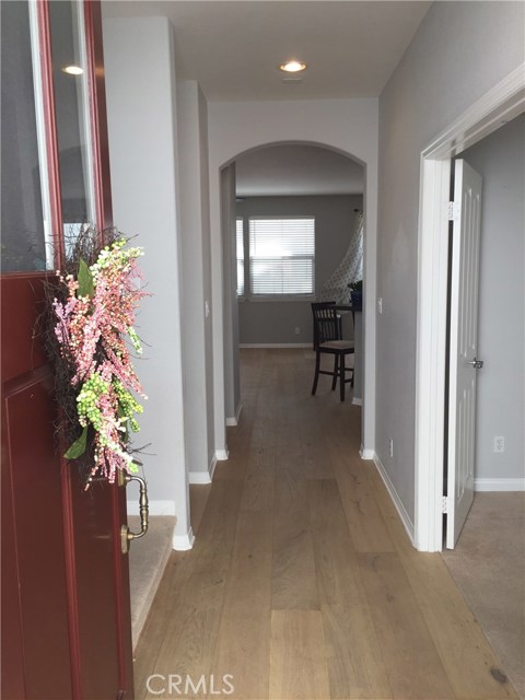 Through this front door you will find lovely floors and woodwork.