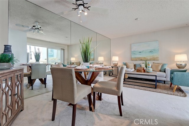 Open floor plan features dining and living room with views of the ocean.