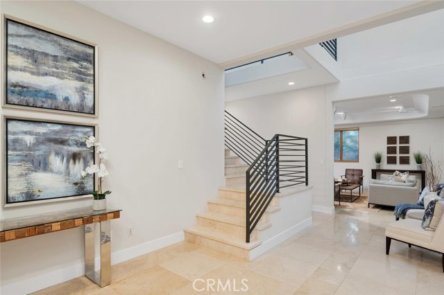 beautiful front entry with high vaulted ceilings and Travertine floors