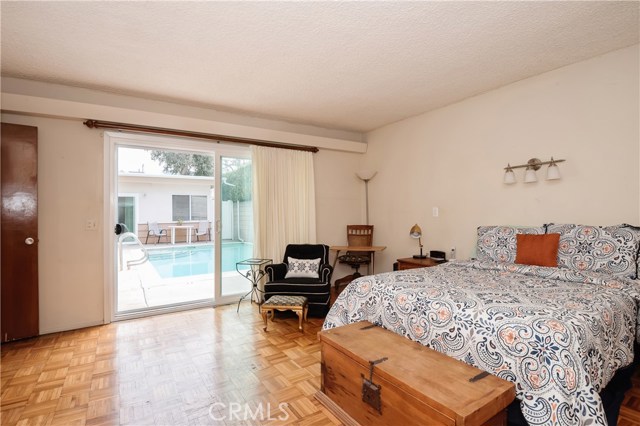 view of pool from large downstairs bedroom