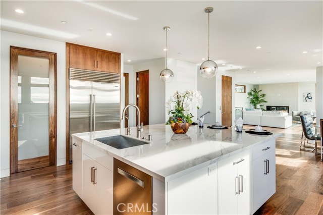 Center island facing Subzero, pantry, looking south at the great room