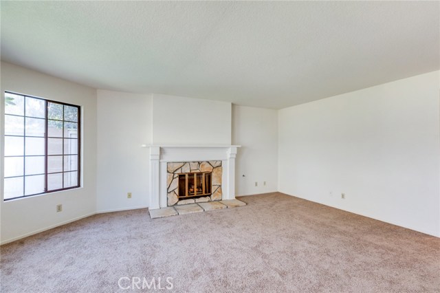 Living room with gas fireplace and bay window for lots of natural light.