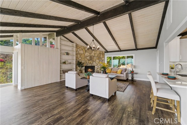 Top floor living room off of kitchen with grand fireplace.