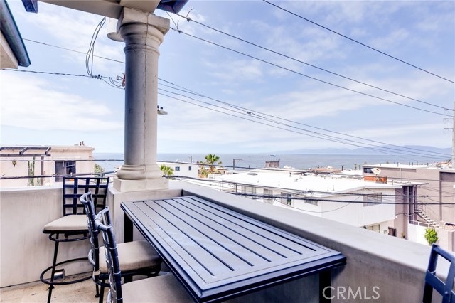 The living room features this private patio with a great ocean view. Enjoy the sound of the ocean waves with a cup of coffee or your favorite evening beverage during sunset.