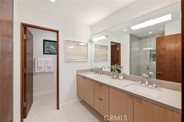 Decadent bath with dual sinks, designer tile selections and custom cabinetry