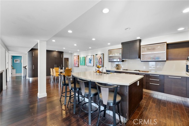 Super open kitchen with island bar counter and casual eating area beyond!