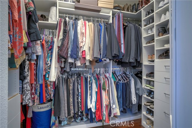 Roomy walk in closet with built in organizer