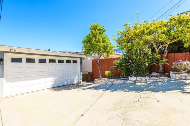 Front of house facing the street. Mature lemon tree.