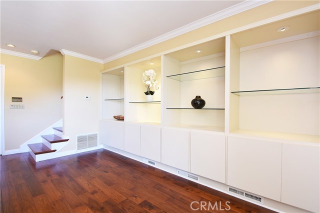 Family Room With Built-in Shelving and Wood Flooring