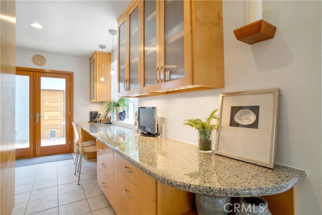 Long counter adjacent to kitchen is super versatile.  Use as a serving buffet when entertaining, homework area, or breakfast area.  Look at all the storage!