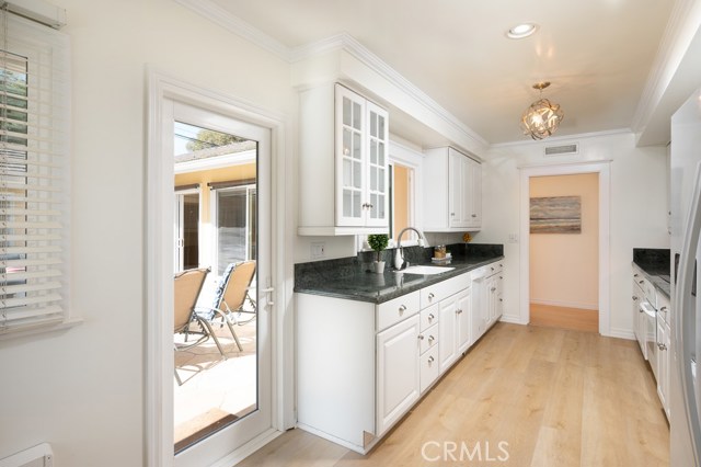 The upgraded kitchen opens to the courtyard and has direct garage access.