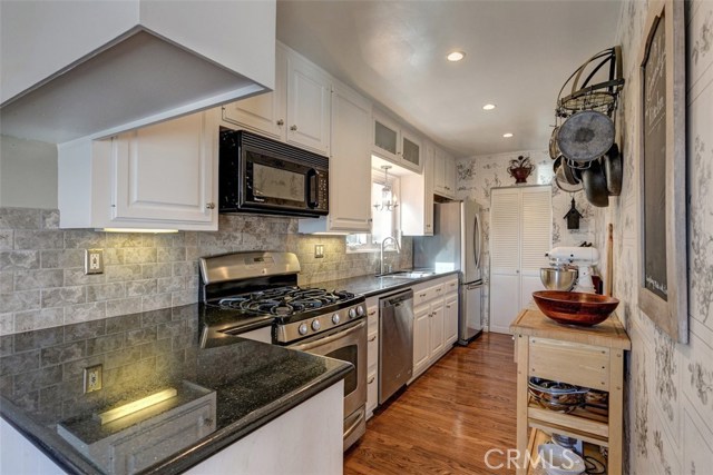 Wonderful kitchen with granite counters, recessed lighting and brushed stainless appliances.