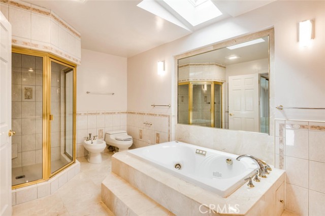 Sumptuous master bath features large jetted soaking tub.