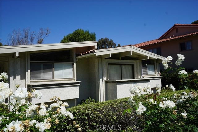 Two stories with 3 light filled bedrooms upstairs.  Middle hall bedroom has balcony. Red tile roof.  Private front Courtyard entrance.