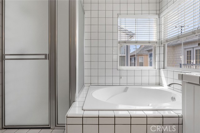 Soaking tub and separate stall shower in main bathroom