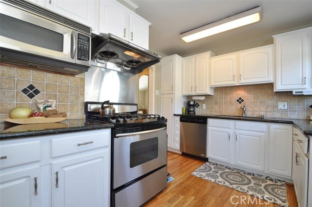 The refinished hardwood floors are also throughout the kitchen, hallway  and the downstairs bedroom