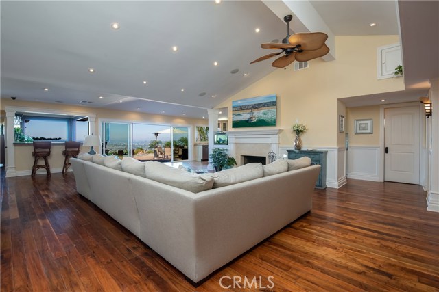 Living room with bar in the background that has both indoor and outdoor seating!