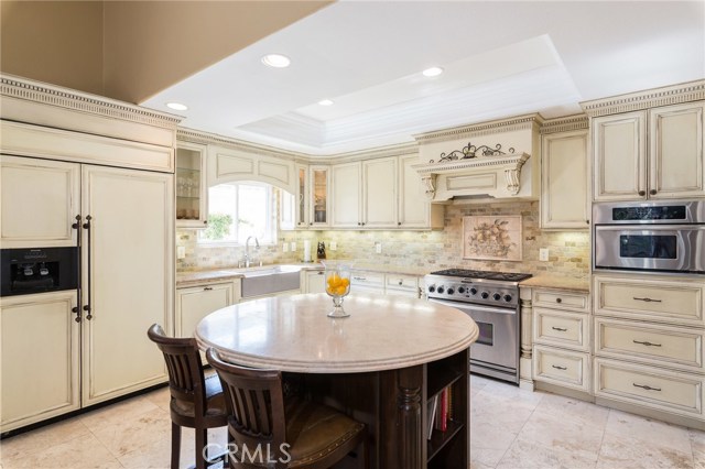 Stunning Kitchen w/ French Oil Rubbed Cabinets, Under-Counter Lighting, Display Cases, Deep Farm Sink & One-of-Kind Round Marble Island, 42” Kitchen Aid Built-in Fridge w/ Icemaker, Dishwasher, Hood, 6-Burner Convection Oven & Convection Microwave Stunning Kitchen w/ French Oil Rubbed Cabinets, Under-Counter Lighting, Display Cases, Deep Farm Sink & One-of-Kind Round Marble Island, 42” Kitchen Aid Built-in Fridge w/ Icemaker, Dishwasher, Hood, 6-Burner Convection Oven & Convection Microwave