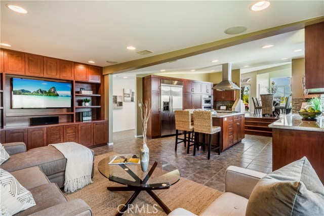 Open concept family room and kitchen with built-in media center.