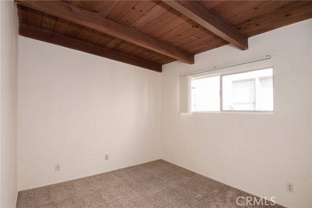 One of two bedrooms in unit 219.  Both have open beam ceailings.