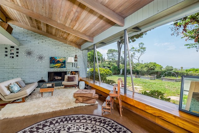 Vaulted ceilings, cork floors, built in wood bench and plate glass windows are show pieces of this beautiful living room