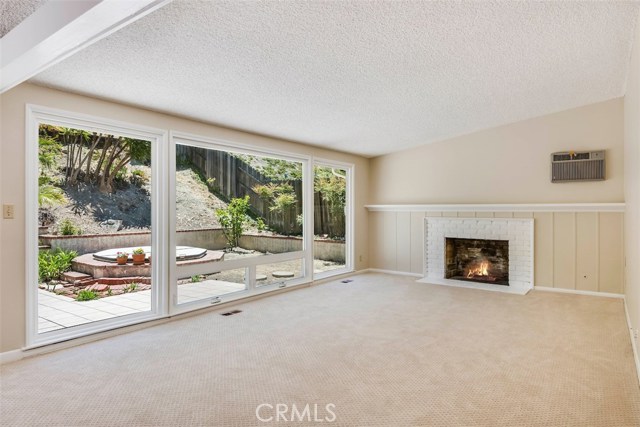 New carpet and paint throughout, the living room with large picture windows essentially brings the outdoors in for hosting indoor/outdoor parties.