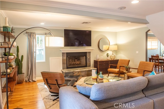 Family/living room with hardwood floor and stone fireplace, wonderful space to unwind.