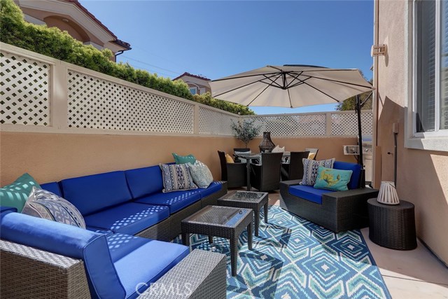 A high lattice fence and greenery gives this enclosed front patio great privacy.