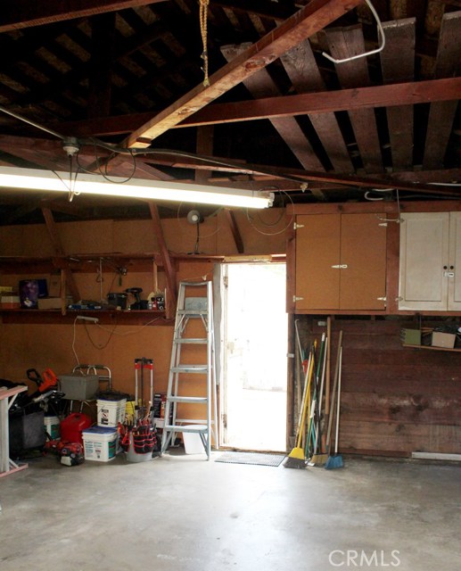 Garage interior, with shelves, cupboards, and workbench