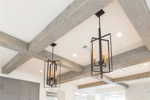 2 large pendants above island, showing the wood beam coffered ceiling detail