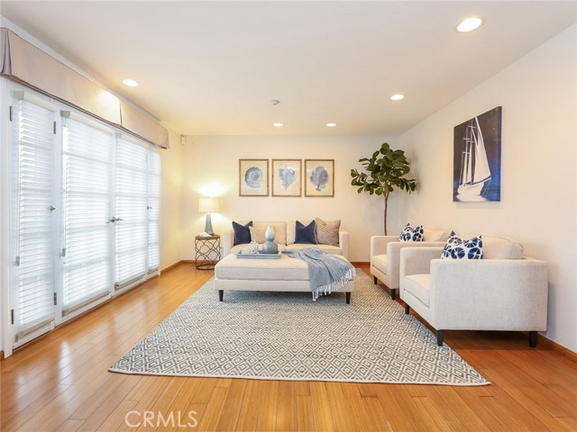 Living room with bamboo floors, recessed lighting and direct access to patio