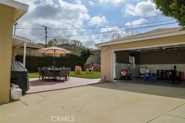 View of backyard & garage from driveway