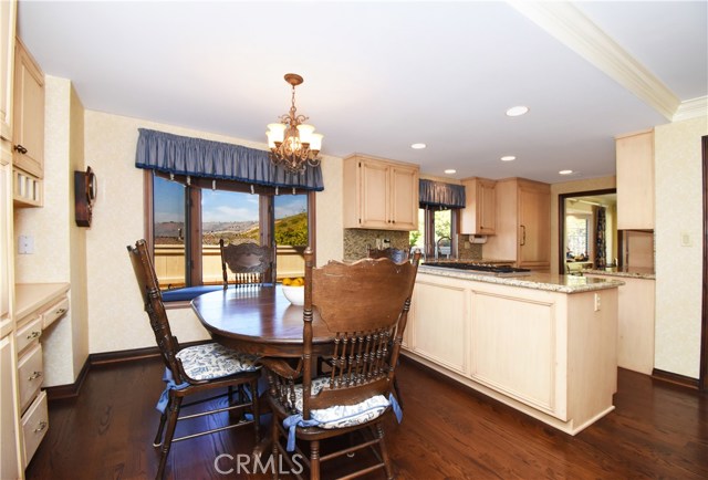 Casual dining area in kitchen, built in desk and storage.