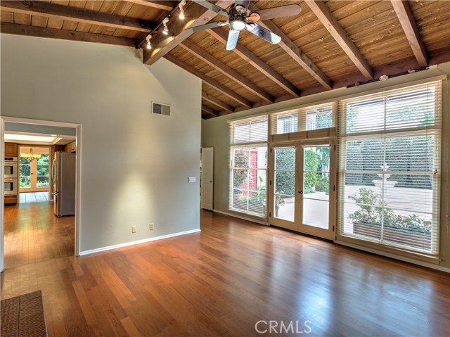 Family room is adjacent to kitchen and opens via french doors to courtyard